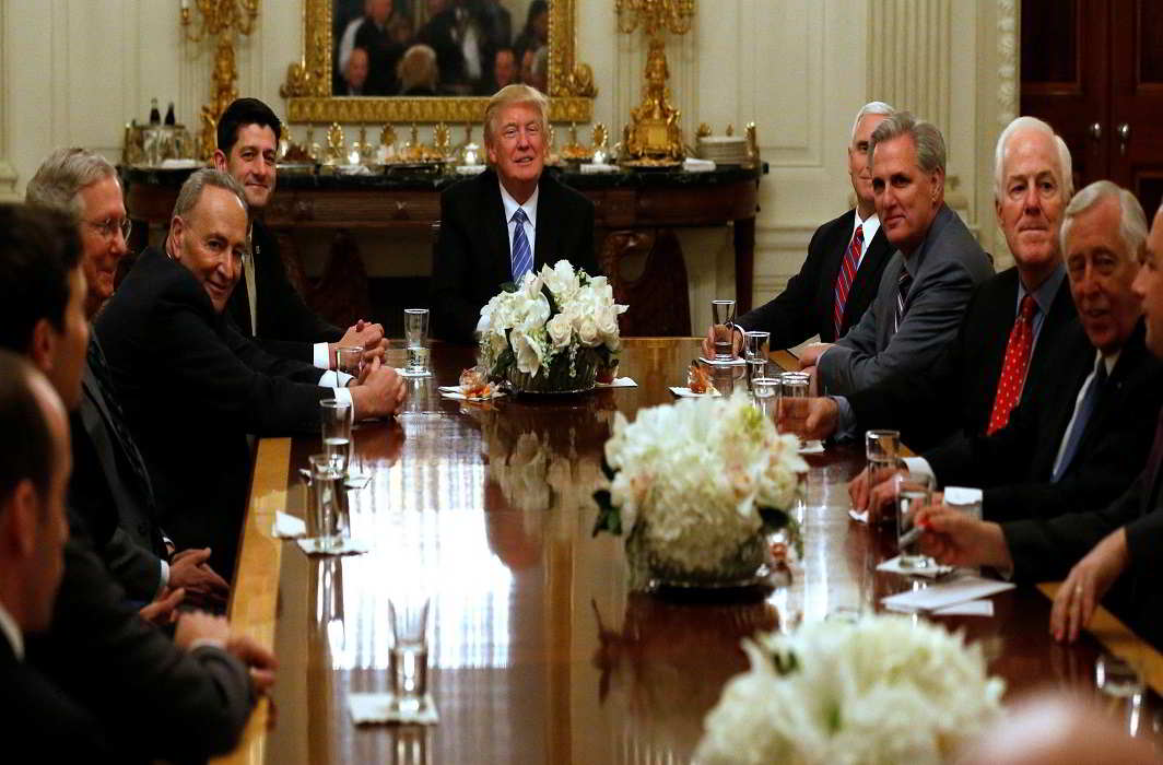 Trump chronicles begin- U.S. President Donald Trump plays host to a reception and meeting with U.S. congressional leaders including Senate Majority Leader Mitch McConnell, Senate Minority Leader Chuck Schumer, House Speaker Paul Ryan, Vice President Mike Pence, Representative Kevin McCarthy, Senator John Cornyn and Representative Steny Hoyer, in the State Dining Room at the White House in Washington, U.S. REUTERS