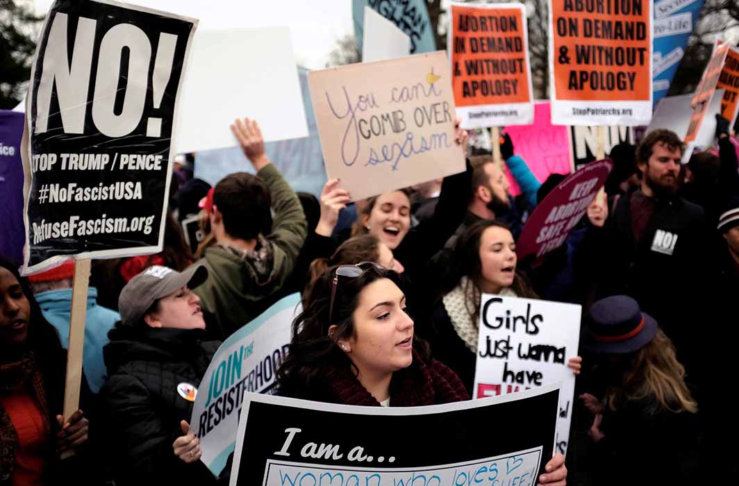 PRIORITIES, PRIORITIES: A pro-life marcher stands in front of pro-choice counter-protesters outside the US Supreme Court where the annual March for Life concludes in Washington, Reuters/UNI