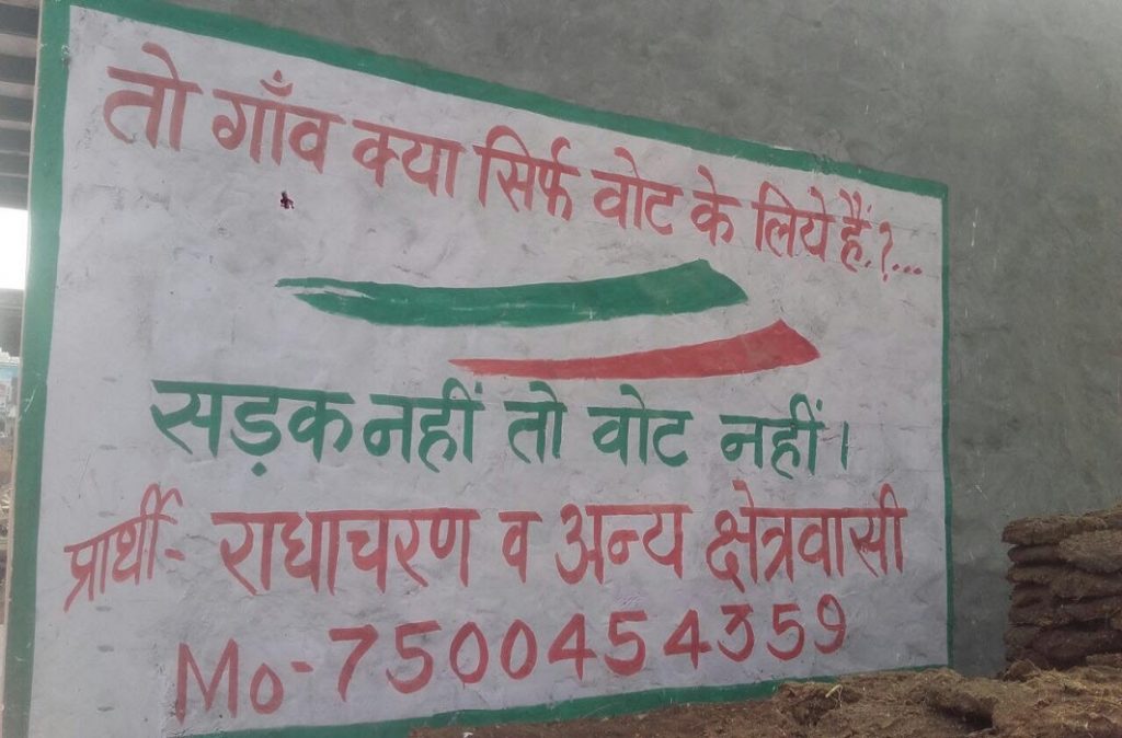 A writing on the wall that clearly says: “No road, no vote”