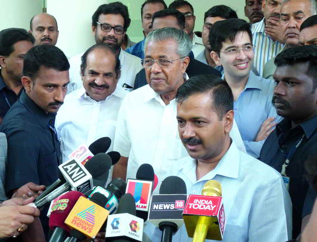 Delhi Chief Minister Arvind Kejriwal and Kerala Chief Minister Pinarayi Vijayan talk to reporters after their meeting at Kerala House in New Delhi, UNI