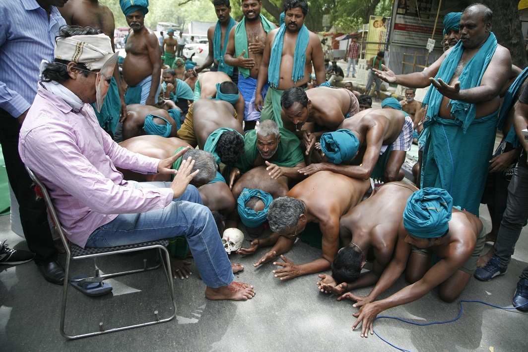 MAKING THEIR POINT: They have posed as corpses, have sat with live rats and snakes held loosely between their teeth, showing what they have been forced to eat in order to survive. (Picture above) A roadside play in which a farmer in a Modi mask refuses pleas from poor farmers. Below is a video capture of the satire clicked by this photographer