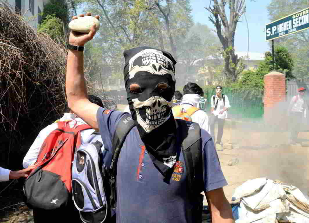 A student with a stone in his hand protesting against the security forces' recent action on students at Pulwama in South Kashmir, UNI