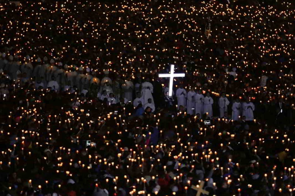 KEEP THE FAITH: Pilgrims attend a candlelight vigil at the Catholic shrine of Fatima, Portugal. The mass there was led by none other than Pope Francis, Reuters/UNI