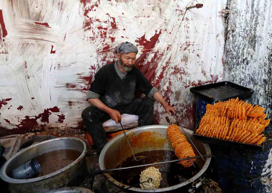 ROSES FLOATING IN SYRUP: A man makes jalebi at a small traditional factory ahead of the Eid al-Adha, in Kabul, Afghanistan, Reuters/UNI