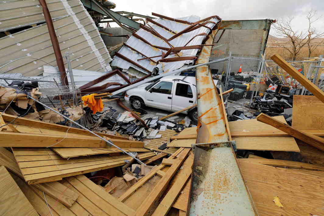 FLATTENED: A car is surrounded by the mangled remains of a recycling and waste management centre that was destroyed by Hurricane Maria in St Croix, US Virgin Islands, Reuters/UNI