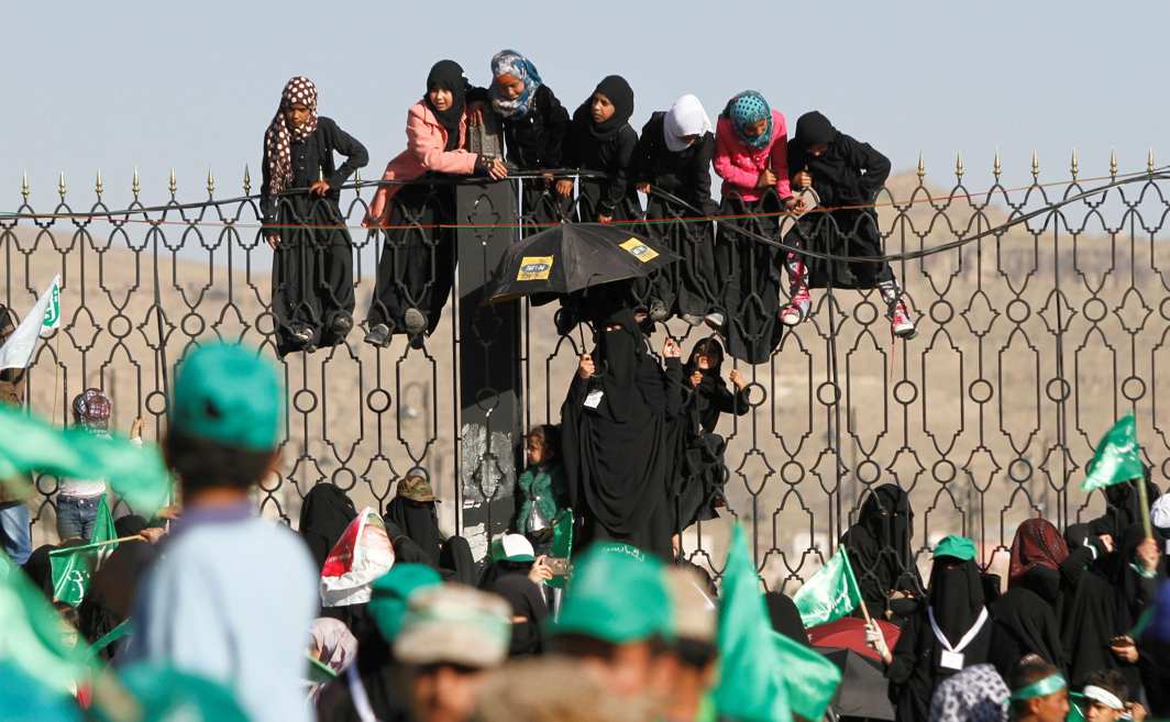 FAITH’S DICHOTOMIES: Houthi supporters hang off an iron fence during a rally marking the birth anniversary of Islam's Prophet Mohammad in Sanaa, Yemen, Reuters/UNI