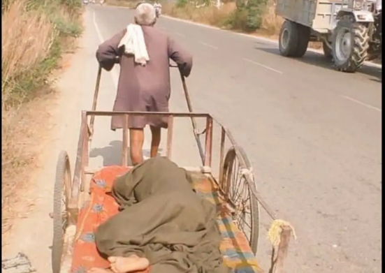 man carries wife on handcart to the hospital