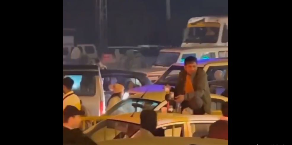 Man sits atop car in Gurugram