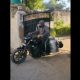 man delivering milk on a Harley Davidson