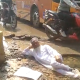 Man lies in water-logged pothole on road