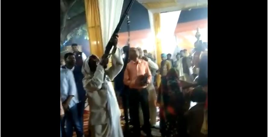 man flaunting weapon during marriage ceremony