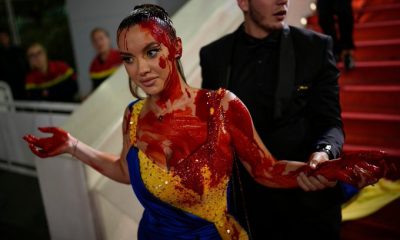 Woman in Ukrainian flag coloured gown spills fake blood on herself at Cannes red carpet; Watch video