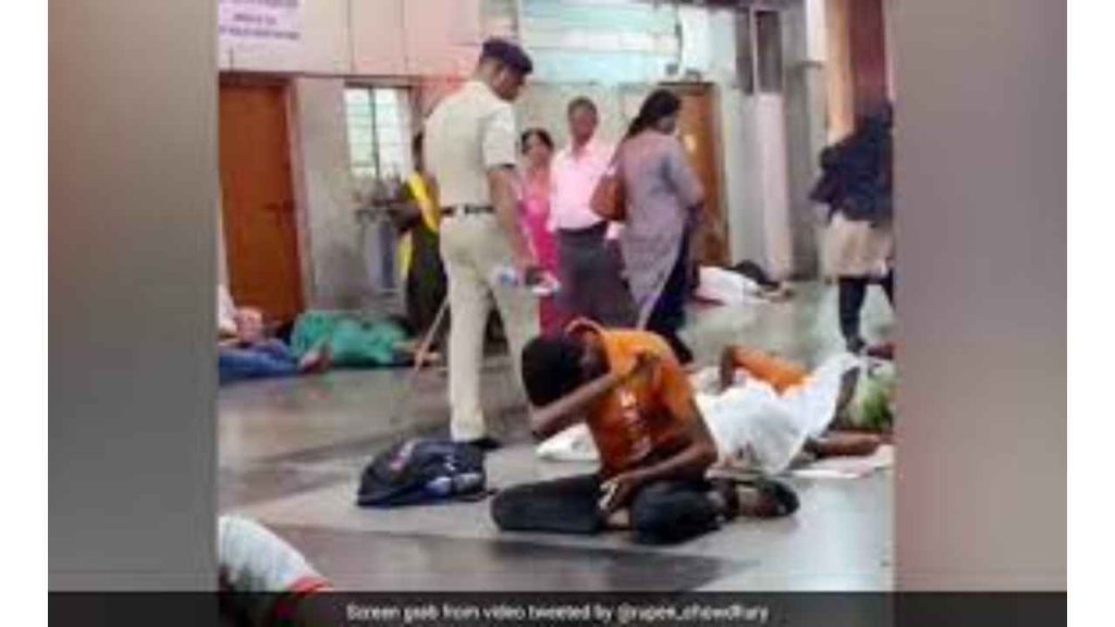 Railway policeman pours water on sleeping passengers at railway station to wake them up