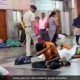 Railway policeman pours water on sleeping passengers at railway station to wake them up