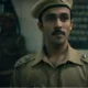 A scene from Black Warrant showing a young jailer walking through Tihar Jail’s corridors, surrounded by inmates.