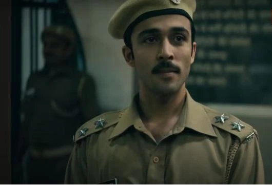 A scene from Black Warrant showing a young jailer walking through Tihar Jail’s corridors, surrounded by inmates.