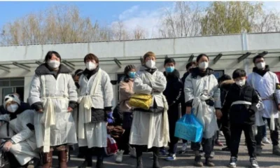 Hospital scene in China with people wearing masks amid Human Metapneumovirus outbreak.