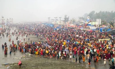 Devotees gathered at a riverbank taking a holy dip during Makar Sankranti celebrations