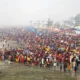 Devotees gathered at a riverbank taking a holy dip during Makar Sankranti celebrations