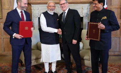 Image shows Narendra Modi and Keir Starmer with Piyush Goyal and Jonathan Reynolds.