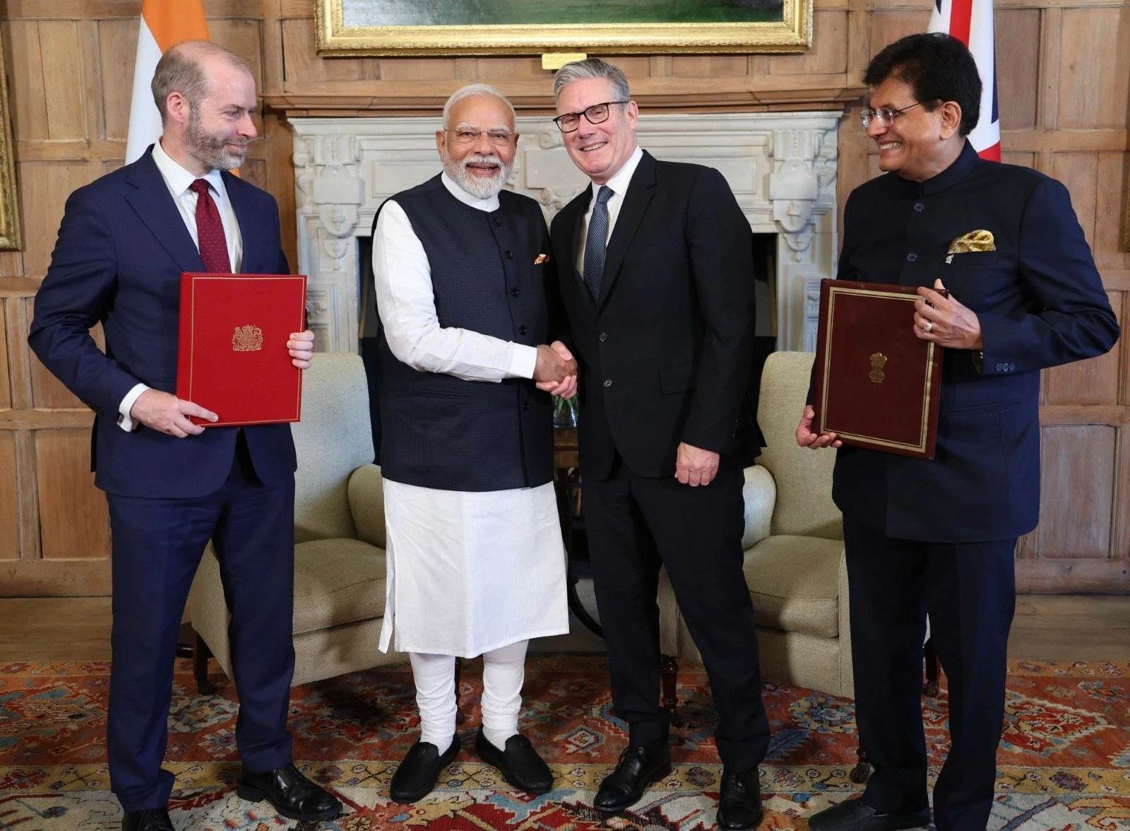 Image shows Narendra Modi and Keir Starmer with Piyush Goyal and Jonathan Reynolds.