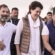 image shows rahul gandhi with priyanka vadra and robert vadra