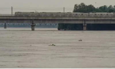 Image shows Yamuna river flowing in spate at danger mark